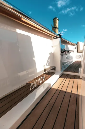 Next Yacht Photos Pics 2022 Fjord 38 Open yacht deck with wooden flooring and clear blue sky.