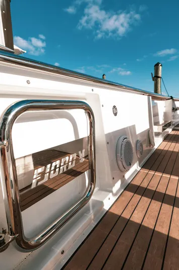 Next Yacht Photos Pics 2022 Fjord 38 Open yacht deck with sleek design and wooden flooring.
