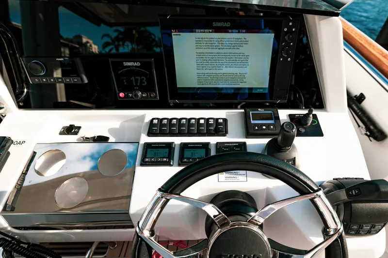 Next Yacht Photos Pics Steering console of 2022 Fjord 38 Open with Simrad navigation system.
