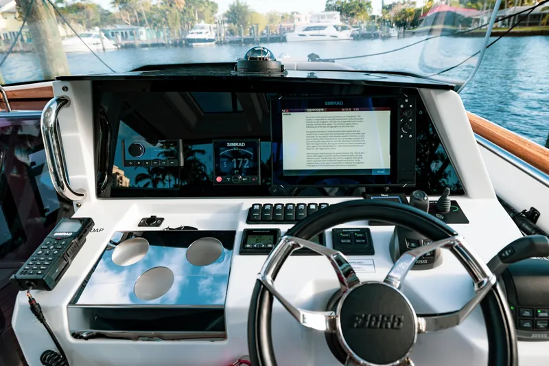 Next Yacht Photos Pics Fjord 38 Open 2022 boat dashboard with steering wheel and navigation screens.