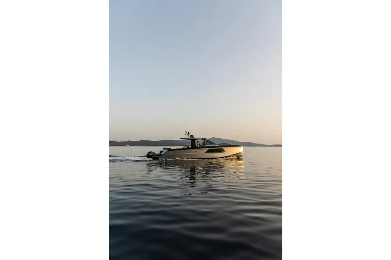  Yacht Photos Pics Maori 46 Outboard 2026 on calm water at sunset.