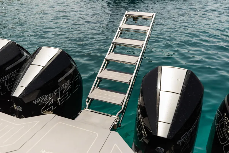  Yacht Photos Pics Maori 46 outboard motors and ladder over clear water, 2026 model.