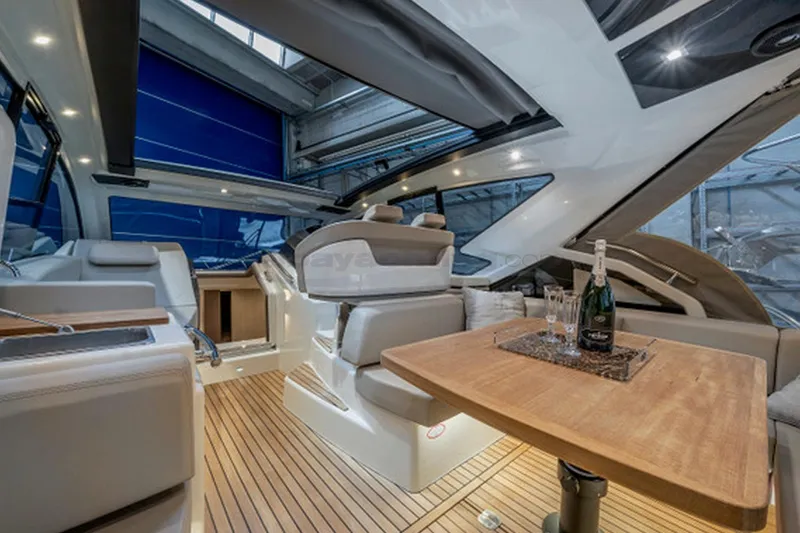  Yacht Photos Pics Luxurious interior of 2020 Cranchi M44 HT yacht with elegant seating and wooden table.