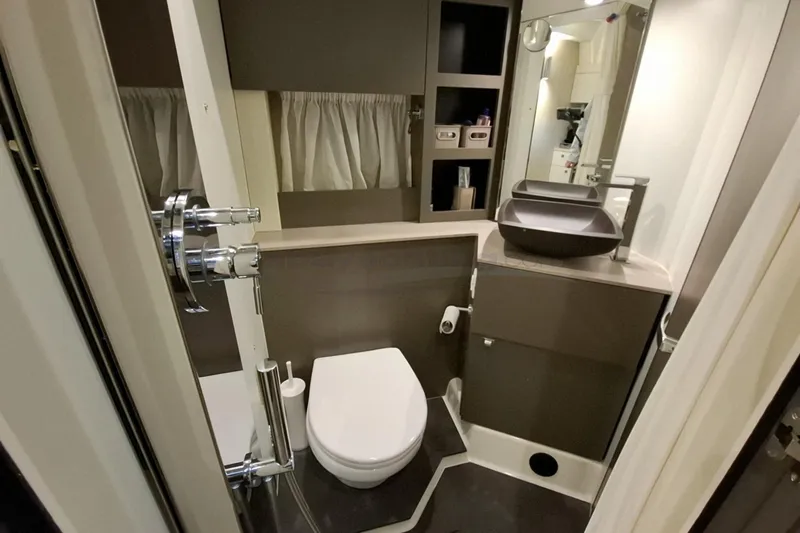  Yacht Photos Pics Modern bathroom interior of 2020 Cranchi M44 HT yacht, featuring sleek fixtures and storage.