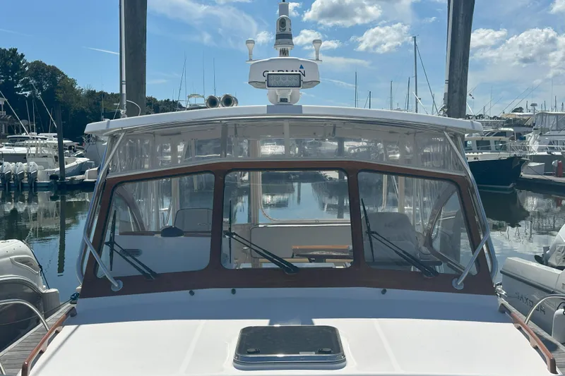At Last 10 Yacht Photos Pics 2017 Fortier F-30 Hardtop boat docked at a marina under a clear blue sky.
