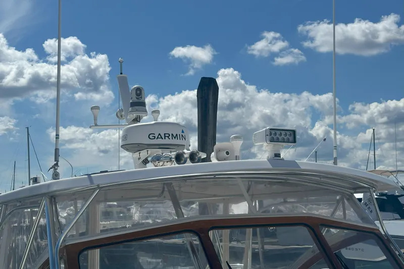 At Last 10 Yacht Photos Pics 2017 Fortier F-30 Hardtop boat with Garmin radar under a cloudy sky.