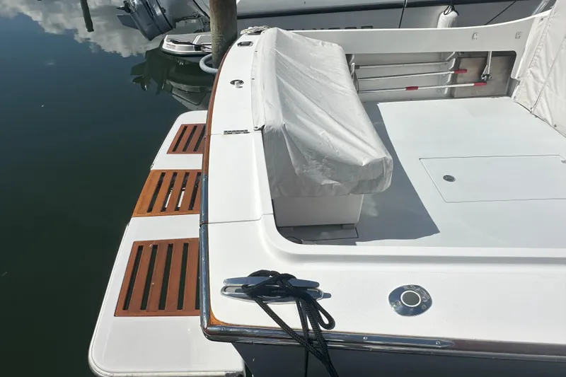 At Last 10 Yacht Photos Pics 2017 Fortier F-30 Hardtop boat with covered seating and wooden deck details.