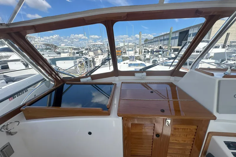 At Last 10 Yacht Photos Pics 2017 Fortier F-30 Hardtop boat interior with wooden finish at marina.