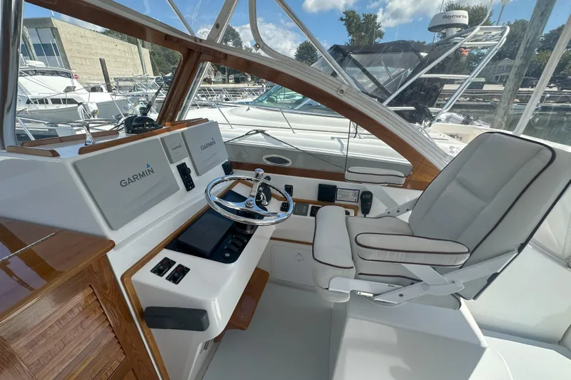 At Last 10 Yacht Photos Pics 2017 Fortier F-30 Hardtop boat interior with Garmin navigation system and captain's chair.