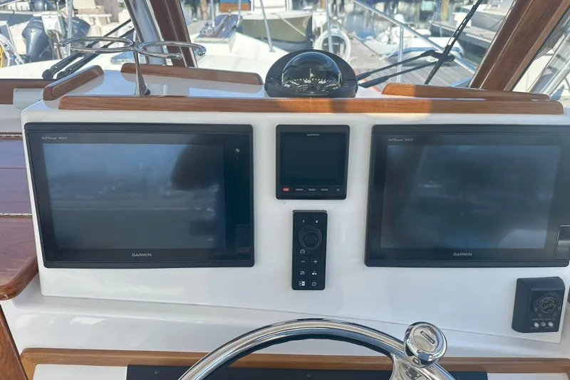 At Last 10 Yacht Photos Pics Control panel of 2017 Fortier F-30 Hardtop with Garmin GPS displays and compass.