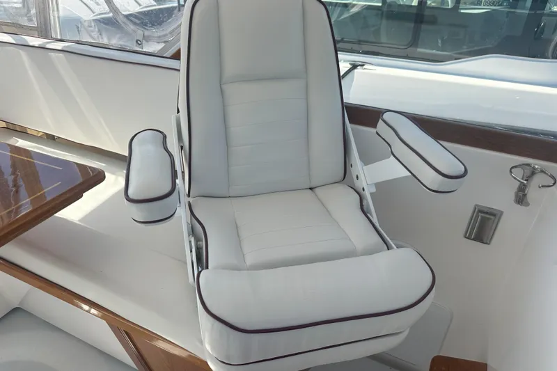 At Last 10 Yacht Photos Pics Luxurious seating on 2017 Fortier F-30 Hardtop boat, featuring white upholstery and wooden accents.