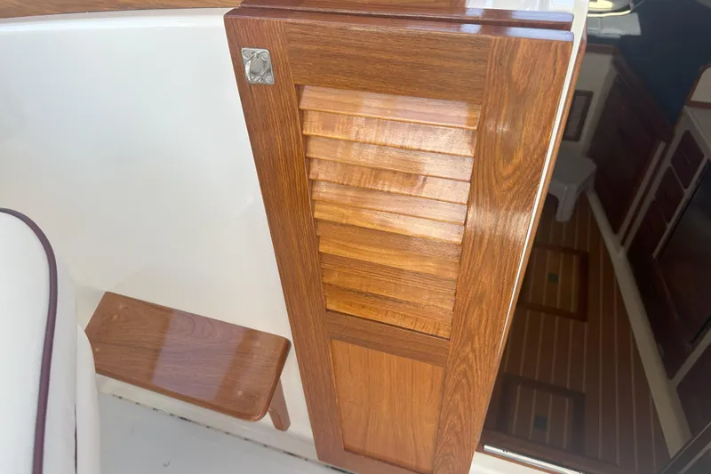 At Last 10 Yacht Photos Pics Wooden interior detail of a 2017 Fortier F-30 Hardtop boat, showcasing craftsmanship.