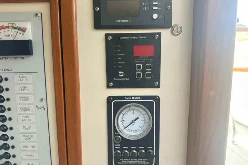 At Last 10 Yacht Photos Pics Control panel of a 2017 Fortier F-30 Hardtop boat with climate and tank gauges.