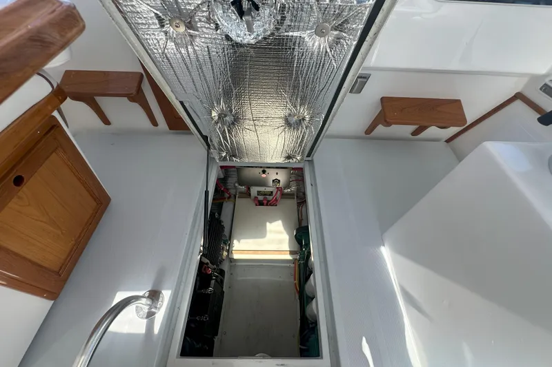 At Last 10 Yacht Photos Pics 2017 Fortier F-30 Hardtop boat interior with open engine compartment.
