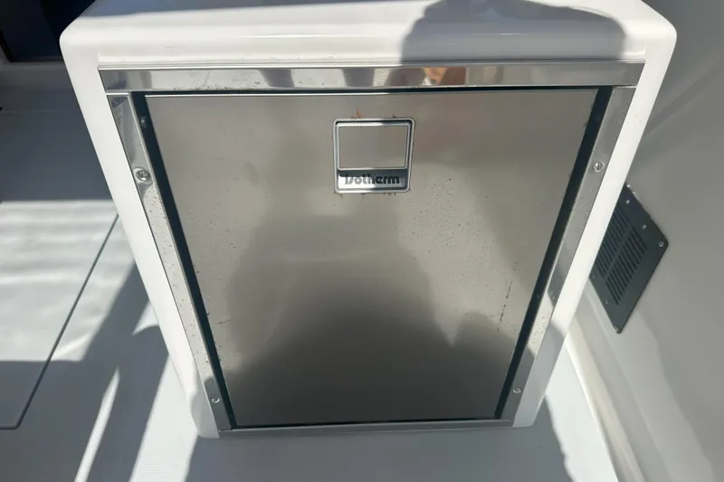 At Last 10 Yacht Photos Pics Stainless steel refrigerator on 2017 Fortier F-30 Hardtop boat, featuring a sleek design.