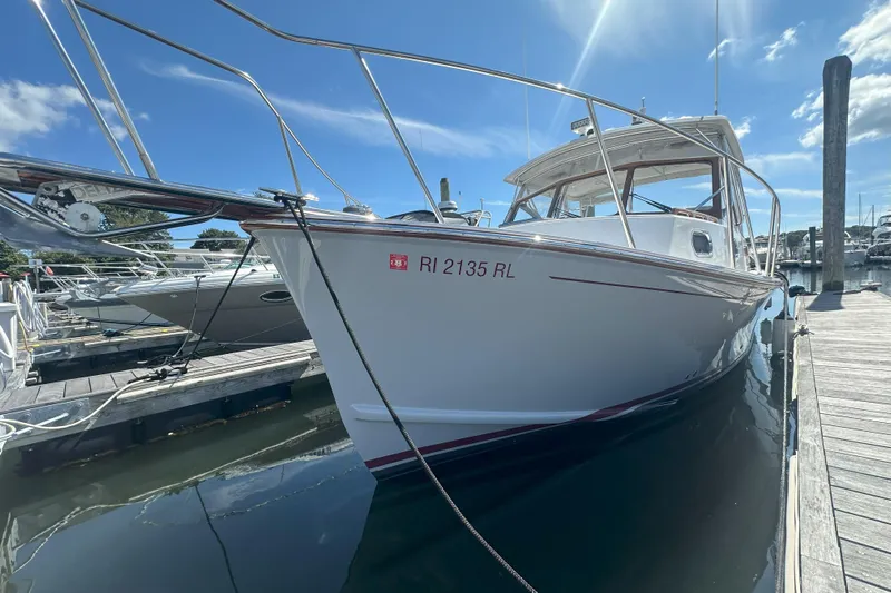 At Last 10 Yacht Photos Pics 2017 Fortier F-30 Hardtop boat docked at marina under clear blue sky.