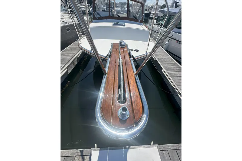 At Last 10 Yacht Photos Pics 2017 Fortier F-30 Hardtop boat docked, showcasing polished wood and metal details.