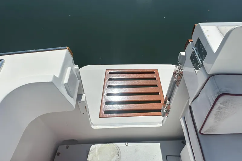 At Last 10 Yacht Photos Pics 2017 Fortier F-30 Hardtop boat deck with wooden slats and cushioned seating.