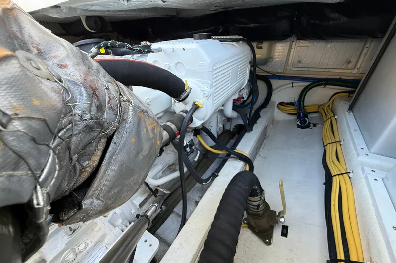 Never Say Never Again Yacht Photos Pics Engine compartment of a 2019 Back Cove Downeast 37 boat, showcasing mechanical components.