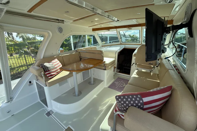 Never Say Never Again Yacht Photos Pics Interior of 2019 Back Cove Downeast 37 yacht with seating, table, and TV.