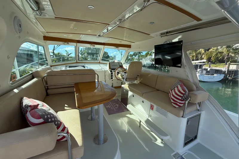 Never Say Never Again Yacht Photos Pics Interior of 2019 Back Cove Downeast 37 yacht with seating, table, and helm.