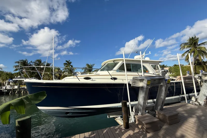 Never Say Never Again Yacht Photos Pics 2019 Back Cove Downeast 37 boat docked under a clear blue sky.