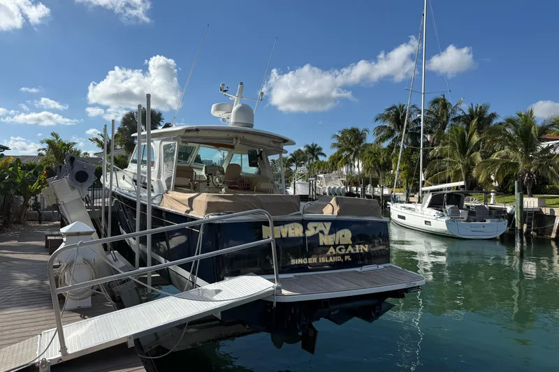 Never Say Never Again Yacht Photos Pics 2019 Back Cove Downeast 37 docked in a tropical marina setting.