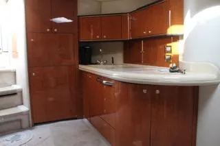  Yacht Photos Pics Interior of 2000 Sea Ray Sundancer yacht with wooden cabinetry and compact kitchen area.