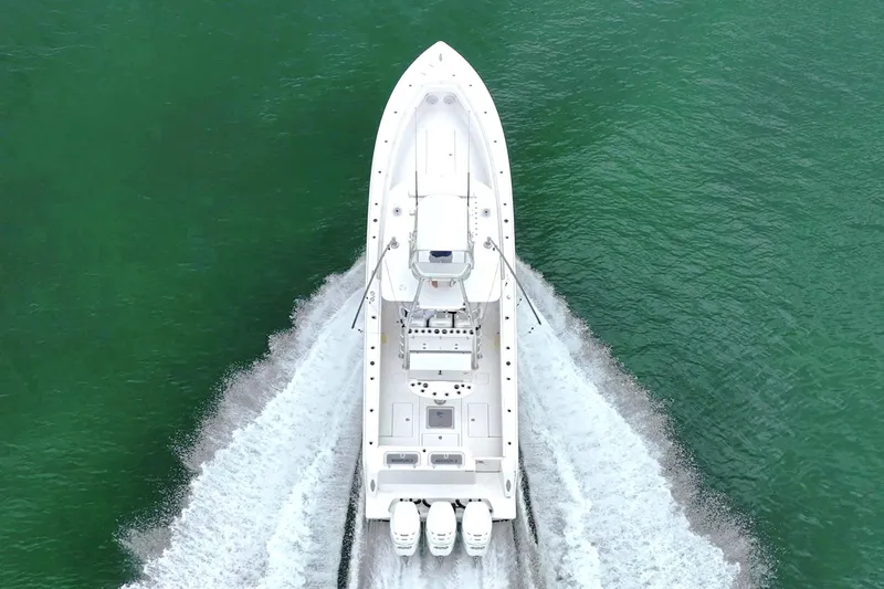  Yacht Photos Pics Aerial view of 2023 Contender 39 ST boat cruising on green water.