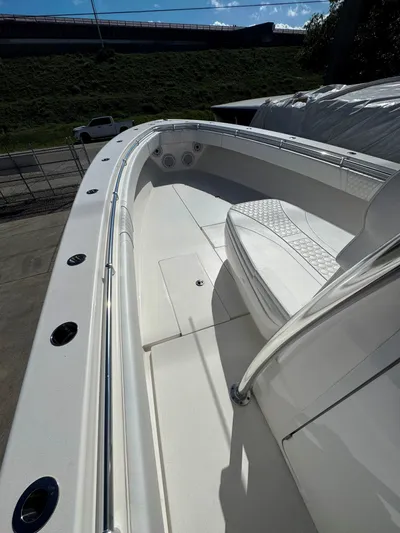  Yacht Photos Pics 2023 Contender 39 ST boat, sleek white deck with cushioned seating, docked outdoors.