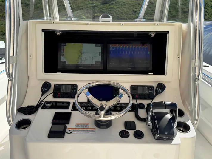  Yacht Photos Pics 2023 Contender 39 ST boat dashboard with navigation screens and controls.