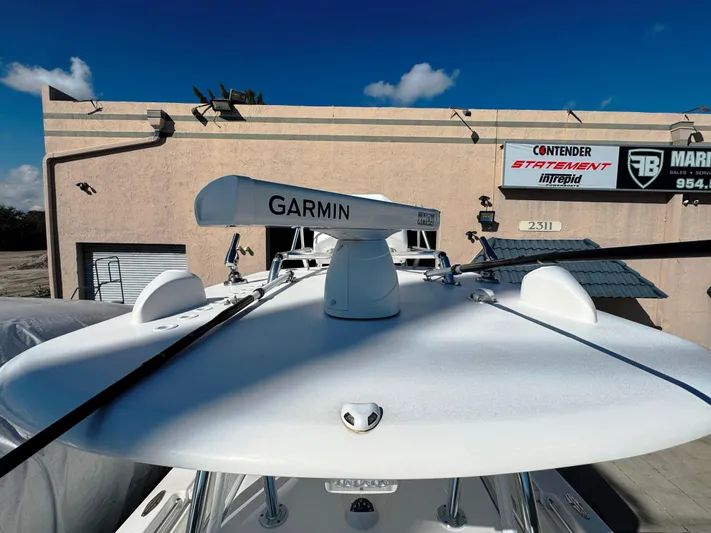  Yacht Photos Pics 2023 Contender 39 ST boat with Garmin radar, parked near a building under a clear sky.
