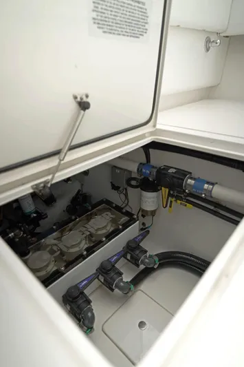  Yacht Photos Pics 2023 Contender 39 ST boat compartment showcasing internal plumbing and mechanical components.
