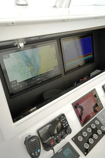  Yacht Photos Pics 2023 Contender 39 ST boat dashboard with navigation screens and controls.