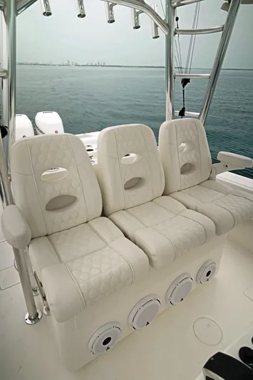  Yacht Photos Pics 2023 Contender 39 ST boat with luxurious white seating and ocean backdrop.
