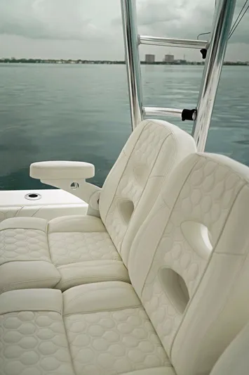  Yacht Photos Pics 2023 Contender 39 ST boat with luxurious white seating on calm water.