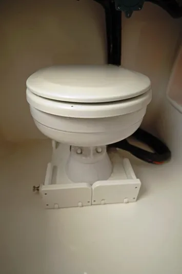  Yacht Photos Pics 2023 Contender 39 ST marine toilet, compact design, white finish.