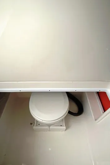  Yacht Photos Pics 2023 Contender 39 ST boat interior with compact marine toilet.