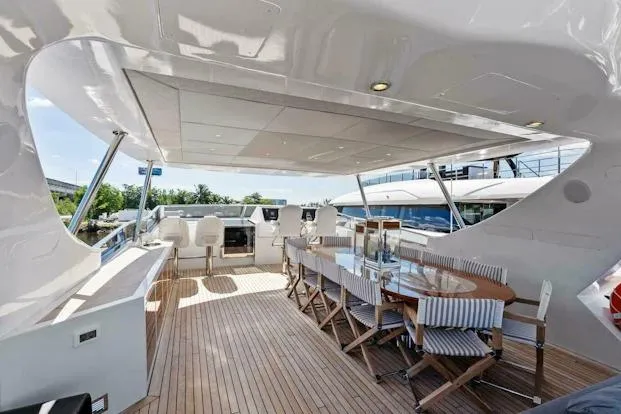  Yacht Photos Pics Luxurious 2006 Tecnomar 35 Nadara yacht deck with elegant seating and dining area.