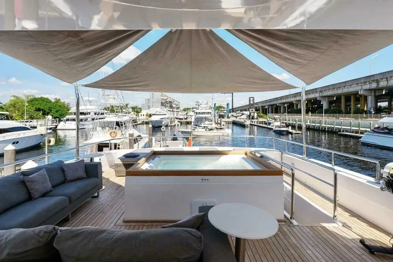  Yacht Photos Pics Luxury Tecnomar 35 Nadara yacht deck with jacuzzi and seating, docked at marina, 2006 model.