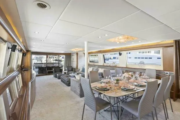  Yacht Photos Pics Luxurious interior of 2006 Tecnomar 35 Nadara yacht with elegant dining area.