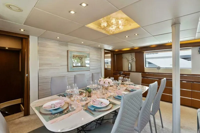  Yacht Photos Pics Luxurious dining area on 2006 Tecnomar 35 Nadara yacht, elegantly set table, modern decor.