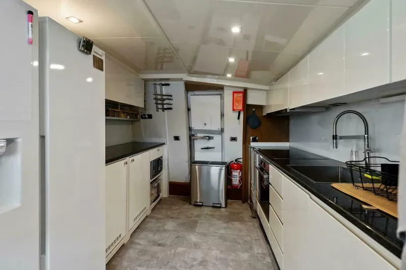  Yacht Photos Pics Modern kitchen interior on 2006 Tecnomar 35 Nadara yacht, featuring sleek appliances and cabinetry.