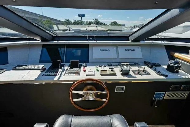  Yacht Photos Pics Control panel of 2006 Tecnomar 35 Nadara yacht with steering wheel and navigation equipment.