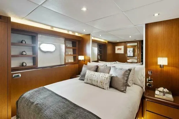  Yacht Photos Pics Luxurious bedroom interior on 2006 Tecnomar 35 Nadara yacht, featuring elegant wood paneling.