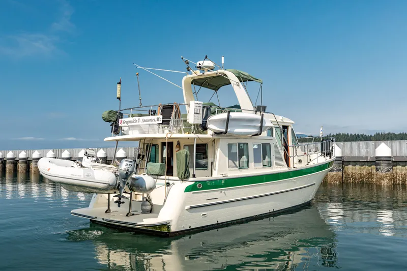 Greymalkin II Yacht Photos Pics 2008 North Pacific 39 Pilothouse yacht docked in calm waters under a clear blue sky.