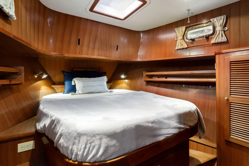 Greymalkin II Yacht Photos Pics Cozy cabin interior of 2008 North Pacific 39 Pilothouse with wood paneling and comfortable bedding.