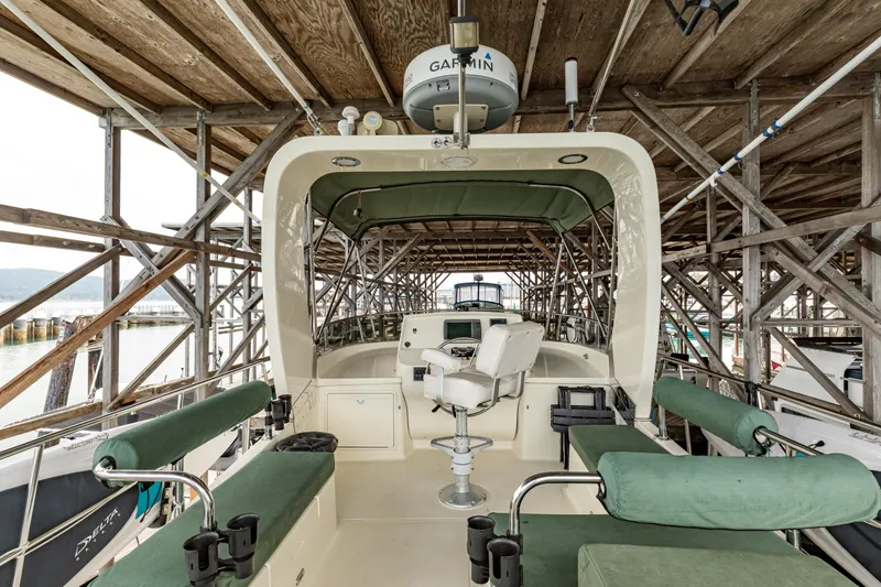 Greymalkin II Yacht Photos Pics 2008 North Pacific 39 Pilothouse boat interior with green seating under wooden dock.
