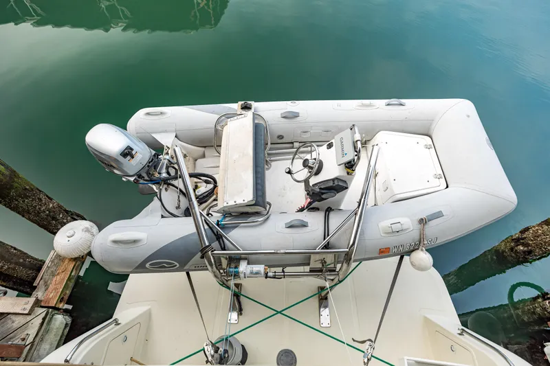 Greymalkin II Yacht Photos Pics Inflatable dinghy on 2008 North Pacific 39 Pilothouse yacht, docked in calm waters.