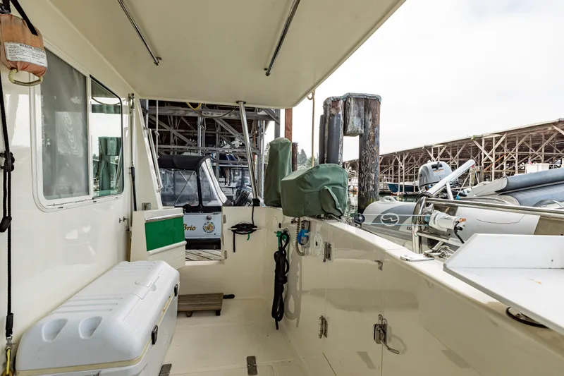 Greymalkin II Yacht Photos Pics 2008 North Pacific 39 Pilothouse boat deck with storage and equipment, docked at marina.